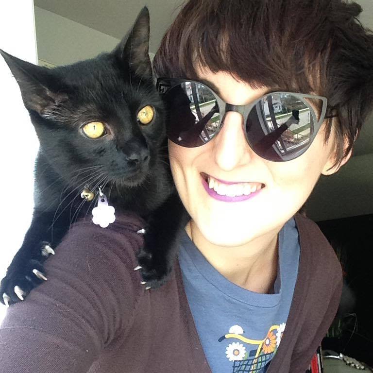 Kate with black cat on her shoulder
